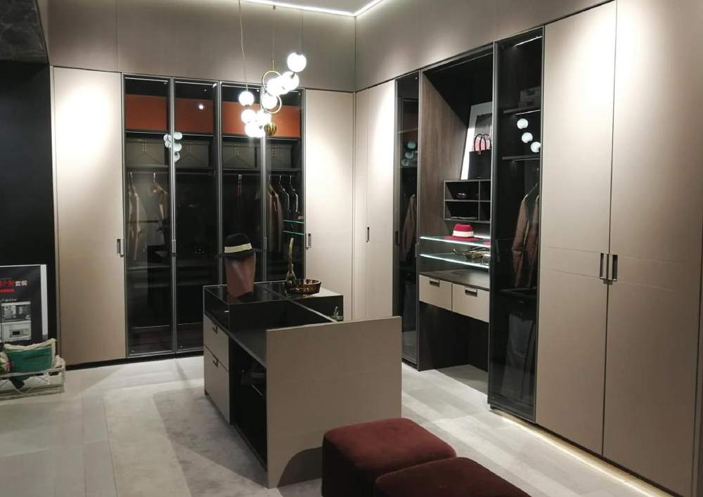 Dressing room with tall glass-front cabinets
