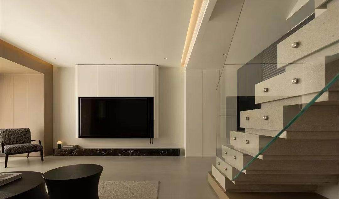 Living room in warm white with a lit floating staircase
